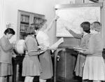 Students and Teacher point at map